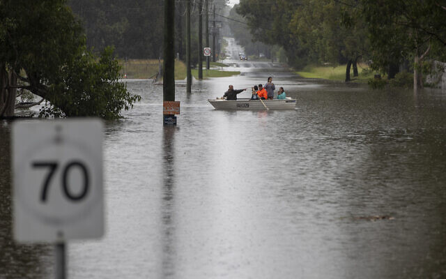 People paddle their boat through flood waters at Londonderry on the western outskirts of Sydney, March 22, 2021 (AP Photo/Mark Baker) People paddle their boat through flood waters at Londonderry on the western outskirts of Sydney, March 22, 2021 (AP Photo/Mark Baker)