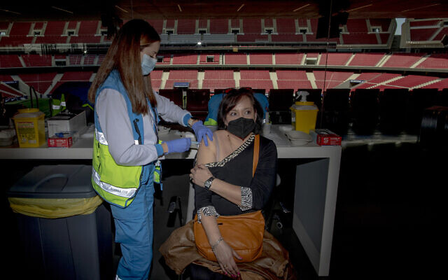 A woman receives a dose of the AstraZeneca vaccine, during a mass vaccination campaign at Wanda Metropolitano stadium in Madrid, Spain, March 24, 2021 (AP Photo/Manu Fernandez) A woman receives a dose of the AstraZeneca vaccine, during a mass vaccination campaign at Wanda Metropolitano stadium in Madrid, Spain, March 24, 2021 (AP Photo/Manu Fernandez)