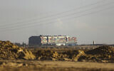 Ever Given, a Panama-flagged cargo ship, that is wedged across the Suez Canal and blocking traffic in the vital waterway is seen March 26, 2021 (AP Photo/Mohamed Elshahed)