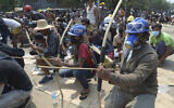 Anti-coup protesters prepare makeshift bow and arrows to confront police in Thaketa township Yangon, Myanmar, March 27, 2021 (AP Photo)