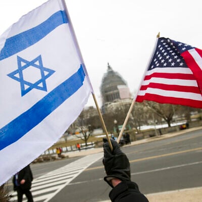 Illustrative: A pro-Israel demonstrator waves flags toward the Capitol in Washington, March 3, 2015. (AP Photo/Cliff Owen) Illustrative: A pro-Israel demonstrator waves flags toward the Capitol in Washington, March 3, 2015. (AP Photo/Cliff Owen)
