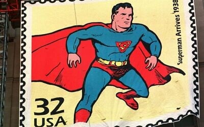 Workers raise a five-story replica of a stamp of Superman on the Terminal Tower, Sept. 10, 1998, in Cleveland (AP Photo/Tony Dejak)