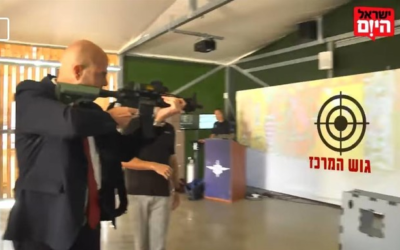 Justice Minister Amir Ohana shoots at a target labeled 'the center bloc,' in an interview with the Israel Hayom newspaper on March 19, 2021. (screenshot: Facebook) Justice Minister Amir Ohana shoots at a target labeled 'the center bloc,' in an interview with the Israel Hayom newspaper on March 19, 2021. (screenshot: Facebook)