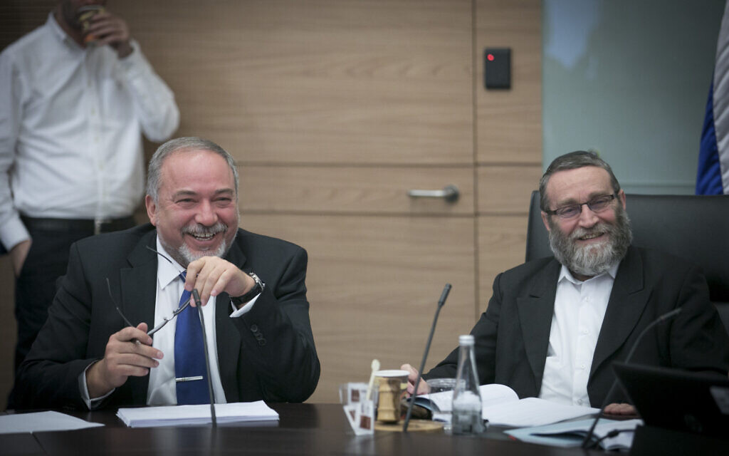 Then-defense minister Avigdor Liberman, left, with Knesset Finance Committee chair MK Moshe Gafni during a Finance Committee meeting at the Knesset on December 6, 2016. (Yonatan Sindel/ Flash90) Then-defense minister Avigdor Liberman, left, with Knesset Finance Committee chair MK Moshe Gafni during a Finance Committee meeting at the Knesset on December 6, 2016. (Yonatan Sindel/ Flash90)