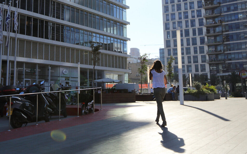 Illustrative: A woman walking toward a building at the Bnei Brak Business Center on October 23, 2017. Yaakov Naumi/FLASH90) Illustrative: A woman walking toward a building at the Bnei Brak Business Center on October 23, 2017. Yaakov Naumi/FLASH90)