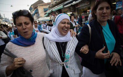 FILE: Hundreds of members from the 'Women Wage Peace' do a flash mob dance at the Mahane Yehuda Market in Jerusalem, during a demonstration calling for peace on International Women’s Day, March 6, 2018. (Hadas Parush/Flash90)