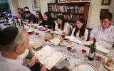 Illustrative: An Israeli family seen during the Passover Seder on the first night of the 8-day long holiday, in Rishon Lezion, March 30, 2018. (Nati Shohat/Flash90/File)