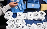 Israelis count the remaining ballots at the Knesset in Jerusalem, a day after the election, early on March 4, 2020. (Olivier Fitoussi/Flash90)
