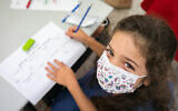 A child wearing a face mask at the Kramim school in Jerusalem on November 1, 2020. (Olivier Fitoussi/Flash90)