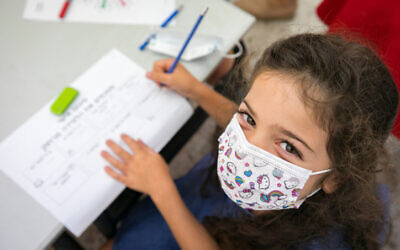 A child wearing a face mask at the Kramim school in Jerusalem on November 1, 2020. (Olivier Fitoussi/Flash90)