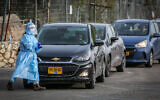 Medical workers collect samples for coronavirus testing in the northern Israeli city of Safed on February 8, 2021 (David Cohen/Flash90)