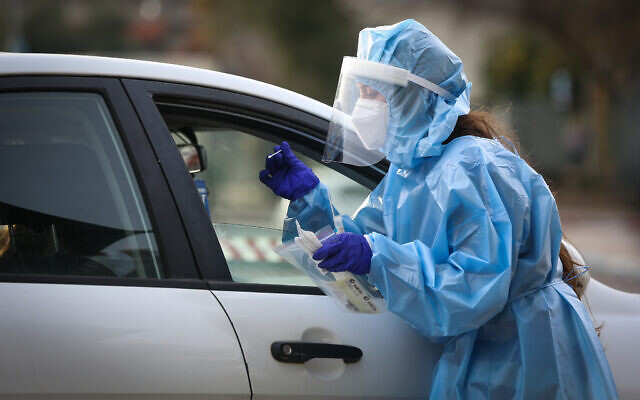 A medical worker collects samples for coronavirus testing in Safed, on February 8, 2021 (David Cohen/Flash90) A medical worker collects samples for coronavirus testing in Safed, on February 8, 2021 (David Cohen/Flash90)