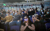 People enjoy artist Ivri Lieder at a concert organized by the Tel Aviv municipality at Bloomfield Stadium, March 5, 2021 (Miriam Alster/FLASH90)