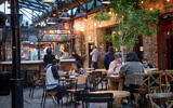 Customers enjoy dining at restaurants after they were recently reopened, in Tel Aviv on March 7, 2021. (Miriam Alster/Flash90)