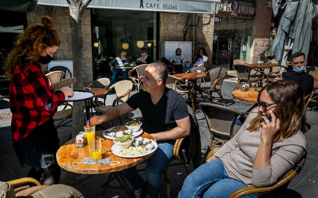 Customers sit at a cafe in Jerusalem on March 7, 2021. (Olivier Fitoussi/Flash90) Customers sit at a cafe in Jerusalem on March 7, 2021. (Olivier Fitoussi/Flash90)