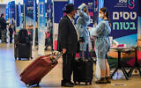 Medical technicians test passengers for the coronavirus at Ben Gurion International Airport, on March 8, 2021. (Avshalom Sassoni/Flash90)