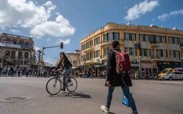Illustrative: A woman bikes in Tel Aviv, on March 12, 2021.(Yahav Gamliel/Flash90) Illustrative: A woman bikes in Tel Aviv, on March 12, 2021.(Yahav Gamliel/Flash90)