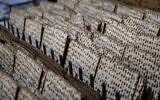 Illustrative: Workers prepare matzah for the upcoming Jewish holiday of Passover at the 'Yehuda Matzos' plant in Jerusalem on March 16, 2021. (Yonatan Sindel/Flash90)