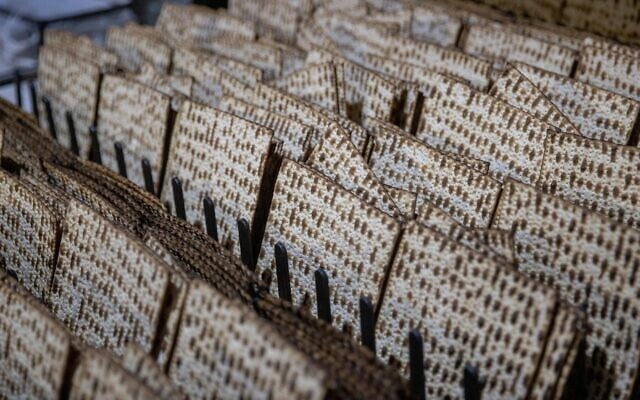 Illustrative: Workers prepare matzah for the upcoming Jewish holiday of Passover at the 'Yehuda Matzos' plant in Jerusalem on March 16, 2021. (Yonatan Sindel/Flash90) Illustrative: Workers prepare matzah for the upcoming Jewish holiday of Passover at the 'Yehuda Matzos' plant in Jerusalem on March 16, 2021. (Yonatan Sindel/Flash90)