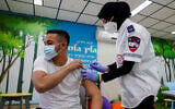A student receives the COVID-19 vaccination at the Amal high school in the southern Israeli city of Beersheba, March 17, 2021 (Flash90)