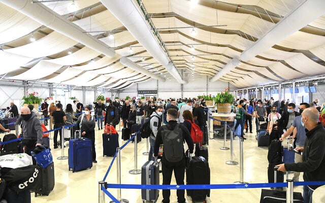 Medical technicians test passengers for COVID-19 at the Ben Gurion International Airport near Tel Aviv on March 8, 2021. (Flash90) Medical technicians test passengers for COVID-19 at the Ben Gurion International Airport near Tel Aviv on March 8, 2021. (Flash90)