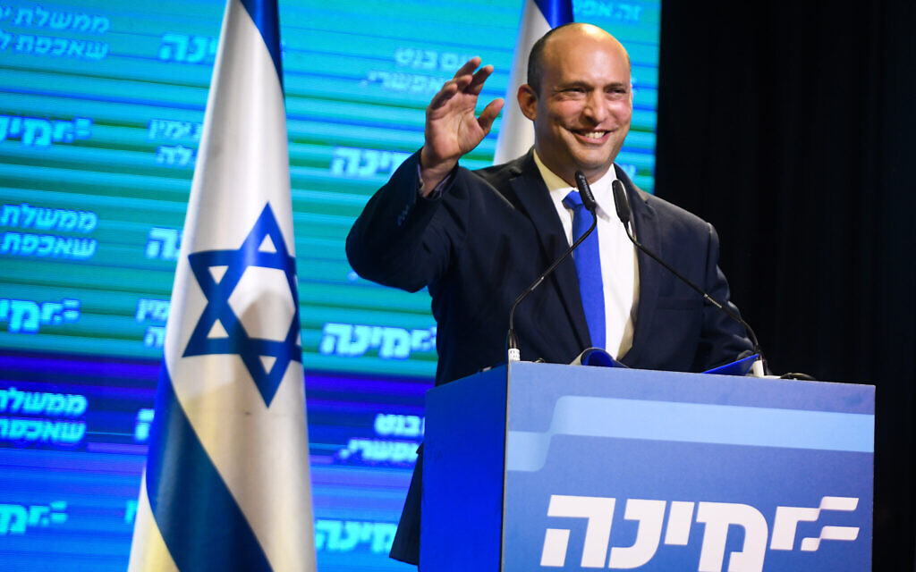 Naftali Bennett, head of the Yamina party seen with Yamina supporters at the party headquarters in Petah Tikva, on election night, on March 23, 2021. (Avi Dishi/Flash90)