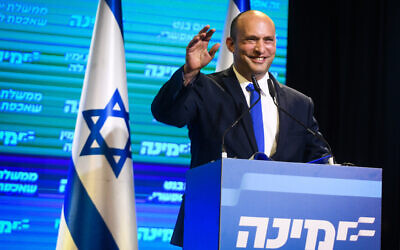 Naftali Bennett, head of the Yamina party seen with Yamina supporters at the party headquarters in Petah Tikva, on election night, on March 23, 2021. (Avi Dishi/Flash90)