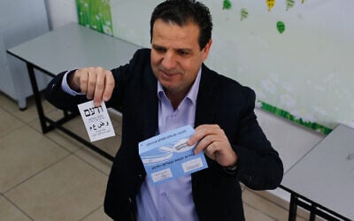 Joint List party leader Ayman Odeh casts his ballot at a voting station in Haifa during the Knesset elections, March 23, 2021. (Jamal Awad/Flash90)