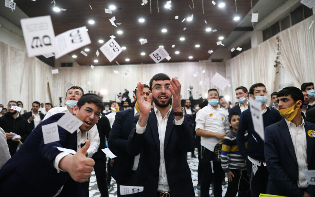 Shas supporters react to the results of the exit polls in Jerusalem on March 23, 2021. (Noam Revkin Fenton/Flash90)