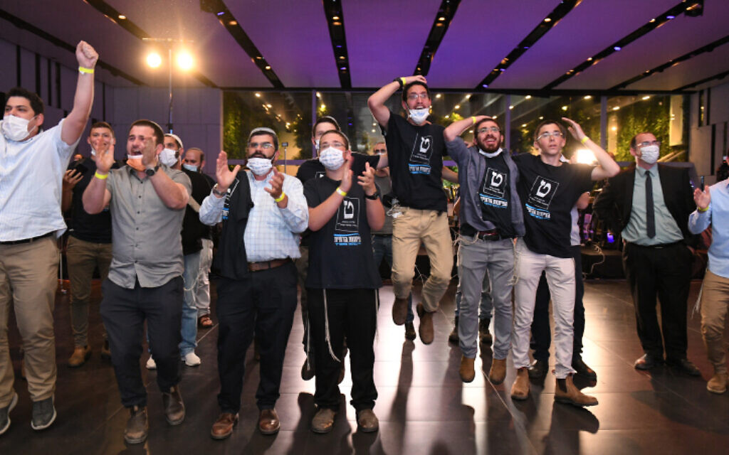 Religious Zionist Party supporters react to the results of exit polls at the party headquarters in Modi'in on March 23, 2021. (Sraya Diamant/Flash90)