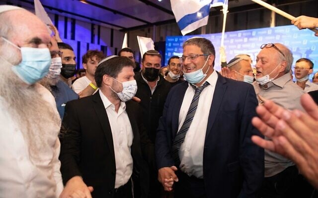 Religious Zionism party chairman Bezalel Smotrich (L) and candidate Itamar Ben Gvir celebrate at the party headquarters in Modi'in on election night, March 23, 2021. (Sraya Diamant/Flash90) Religious Zionism party chairman Bezalel Smotrich (L) and candidate Itamar Ben Gvir celebrate at the party headquarters in Modi'in on election night, March 23, 2021. (Sraya Diamant/Flash90)