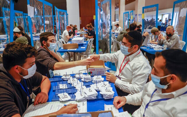 Central Election Committee members count ballots in Jerusalem on March 25, 2020. (Yonatan Sindel/Flash90)