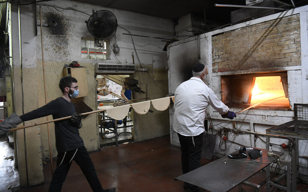 Ultra Orthodox Jews prepare matzos, traditional unleavened bread eaten during Passover, in Kfar Chabad, March 25, 2021 (Yossi Zeliger/Flash90)
