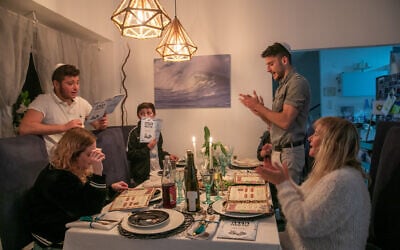 A family seen during the Passover Seder on the first night of the 8-day long Jewish holiday, in Moshav Yashresh on March 27, 2021. (Yossi Aloni/Flash90)