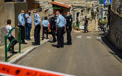 Security forces inspect the scene where a man was shot to death by a police officer after the man attempted to stab him, in Haifa, March 29, 2021. (Roni Ofer/Flash90)