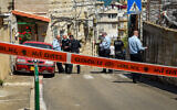 Security forces inspect the scene where a man was shot to death by a police officer after the man attempted to stab him, in Haifa, March 29, 2021. (Roni Ofer/Flash90)