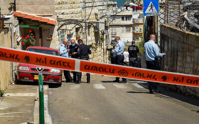 Security forces inspect the scene where a man was shot to death by a police officer after the man attempted to stab him, in Haifa, March 29, 2021. (Roni Ofer/Flash90)