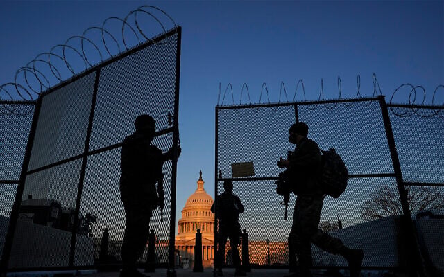 US National Guard soldiers open a gate of the razor wire-topped perimeter fence around the Capitol building in Washington, March 8, 2021. (AP Photo/Carolyn Kaster) US National Guard soldiers open a gate of the razor wire-topped perimeter fence around the Capitol building in Washington, March 8, 2021. (AP Photo/Carolyn Kaster)