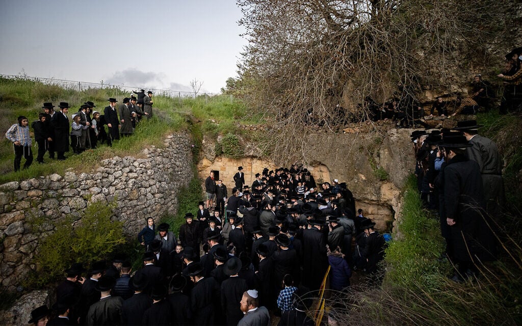 Ultra-Orthodox men collect water from a mountain spring outside Jerusalem on March 25, 2021. The water will be used in the making of matzah. (Yonatan Sindel/Flash90)