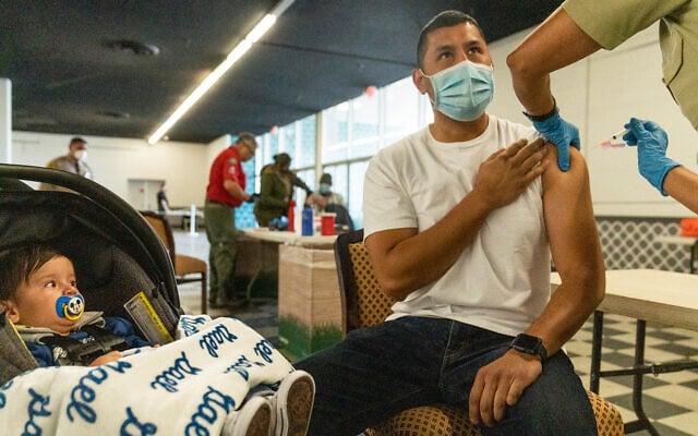 Aman is inoculated with the Moderna COVID-19 vaccine at a mobile vaccination clinic in Pomona, California, March 5, 2021. (AP Photo/Damian Dovarganes) Aman is inoculated with the Moderna COVID-19 vaccine at a mobile vaccination clinic in Pomona, California, March 5, 2021. (AP Photo/Damian Dovarganes)