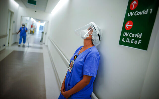 A health worker pauses in the ICU unit for COVID-19 patients at the Hospital das Clinicas in Porto Alegre, Brazil, March 19, 2021. (AP Photo/Jefferson Bernardes) A health worker pauses in the ICU unit for COVID-19 patients at the Hospital das Clinicas in Porto Alegre, Brazil, March 19, 2021. (AP Photo/Jefferson Bernardes)