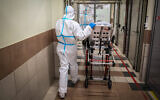 Medical workers evacuate at the coronavirus unit of the Ziv Medical in Safed, on February 4, 2021. (David Cohen/Flash90)