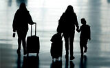 Travelers walk in Salt Lake City International Airport, in Salt Lake City, Utah, March 9, 2021. (AP Photo/Rick Bowmer)