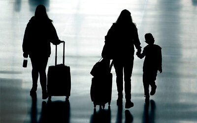 Travelers walk in Salt Lake City International Airport, in Salt Lake City, Utah, March 9, 2021. (AP Photo/Rick Bowmer)