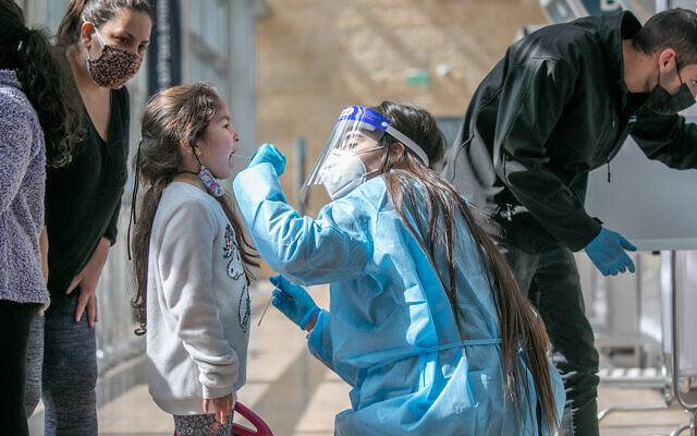 A technician collects nasal swab samples for COVID-19 testing at Ben-Gurion International Airport on February 28, 2021. (Yossi Aloni/Flash90) A technician collects nasal swab samples for COVID-19 testing at Ben-Gurion International Airport on February 28, 2021. (Yossi Aloni/Flash90)