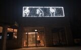 The neon hands spelling out the word 'light' in Hebrew and Arabic sign language at the new home of the Mekudeshet cultural organization in Jerusalem, opened during the coronavirus pandemic (Jessica Steinberg/Times of Israel)