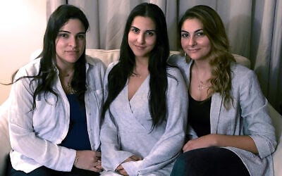In this Nov. 5, 2019, photo, from left, Guila, Macy and Zoya Fakhoury, three of Amer Fakhoury's four daughters, gather in Salem, New Hampshire. (AP Photo/Kathy McCormack)