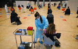 Health workers administer doses of the AstraZeneca vaccine against COVID-19 inside the convention center known as "La Nuvola", The Cloud, in Rome, Italy, March 10, 2021. (AP Photo/Andrew Medichini)
