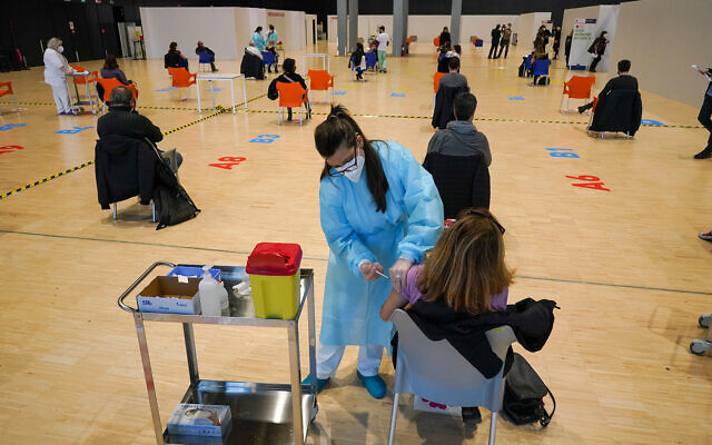 Health workers administer doses of the AstraZeneca vaccine against COVID-19 inside the convention center known as "La Nuvola", The Cloud, in Rome, Italy, March 10, 2021. (AP Photo/Andrew Medichini) Health workers administer doses of the AstraZeneca vaccine against COVID-19 inside the convention center known as "La Nuvola", The Cloud, in Rome, Italy, March 10, 2021. (AP Photo/Andrew Medichini)