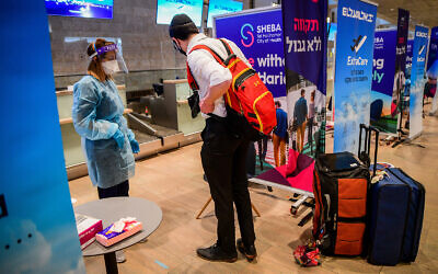 Medical technicians test passengers for COVID-19 at Ben Gurion International Airport near Tel Aviv on March 8, 2021. (Avshalom Sassoni/Flash90)